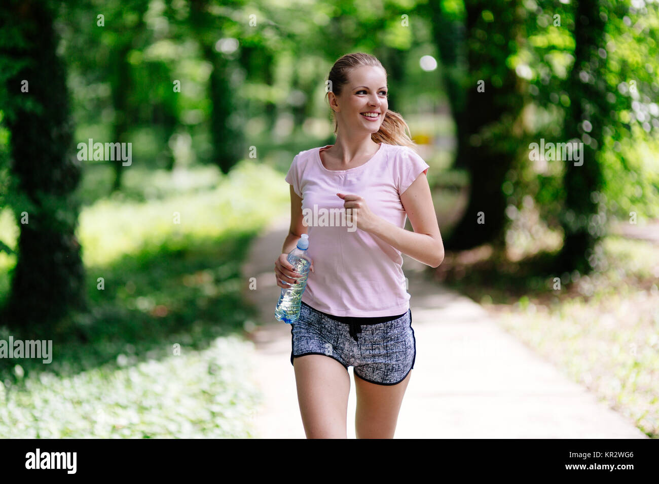 Beautiful jogging woman in nature Stock Photo