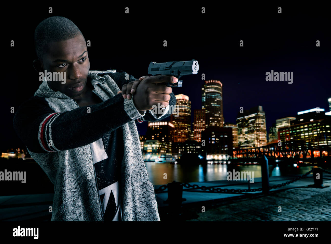 Black young man shooting someone with a gun Stock Photo