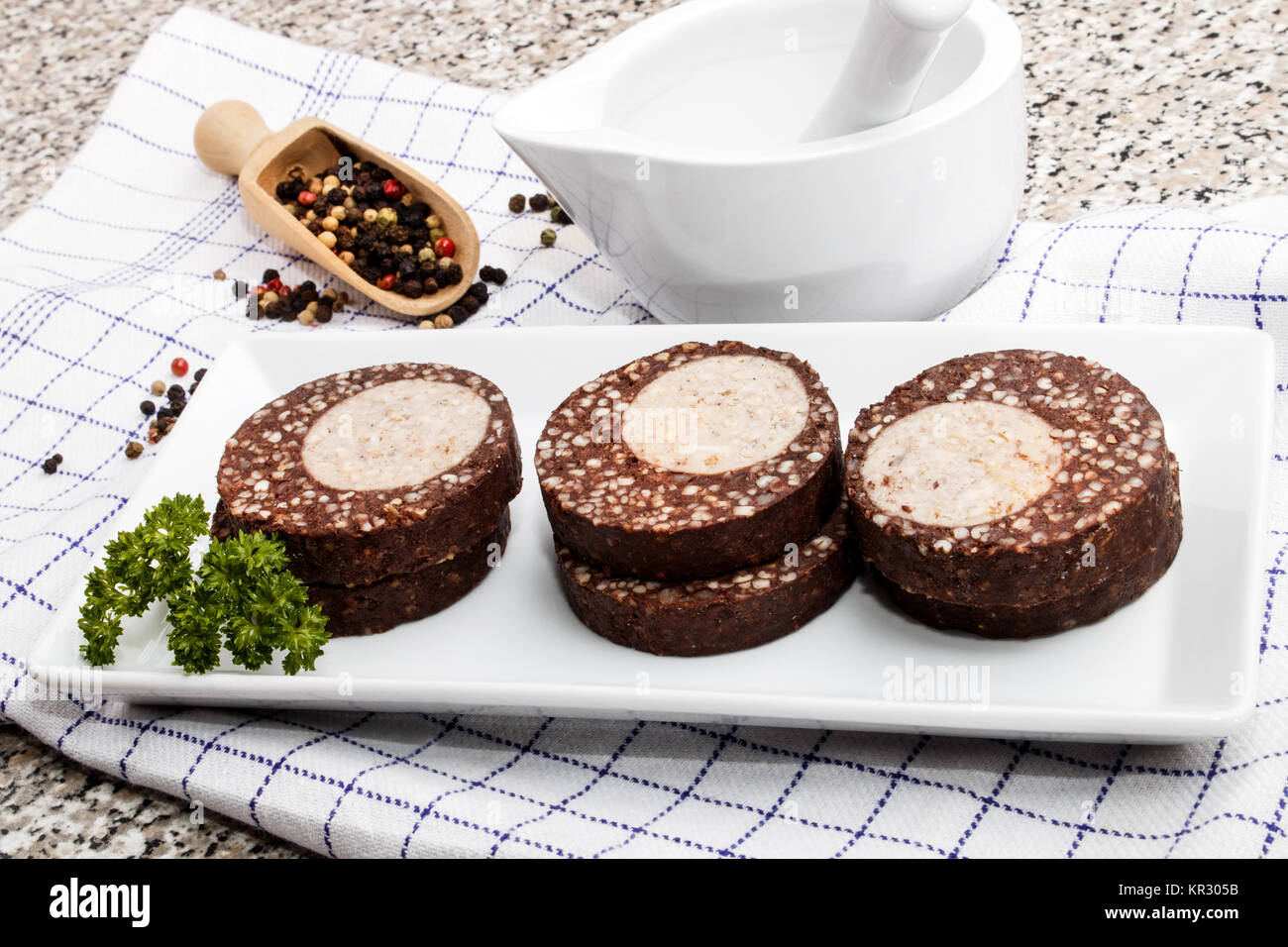 raw spicy black and white pork pudding roll made with oatmeal on a