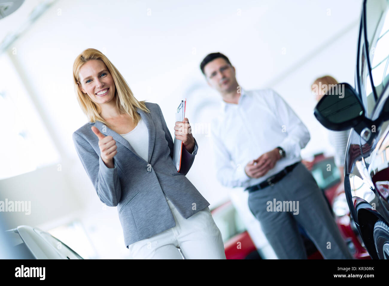 Picture of professional salesperson working in car dealership Stock