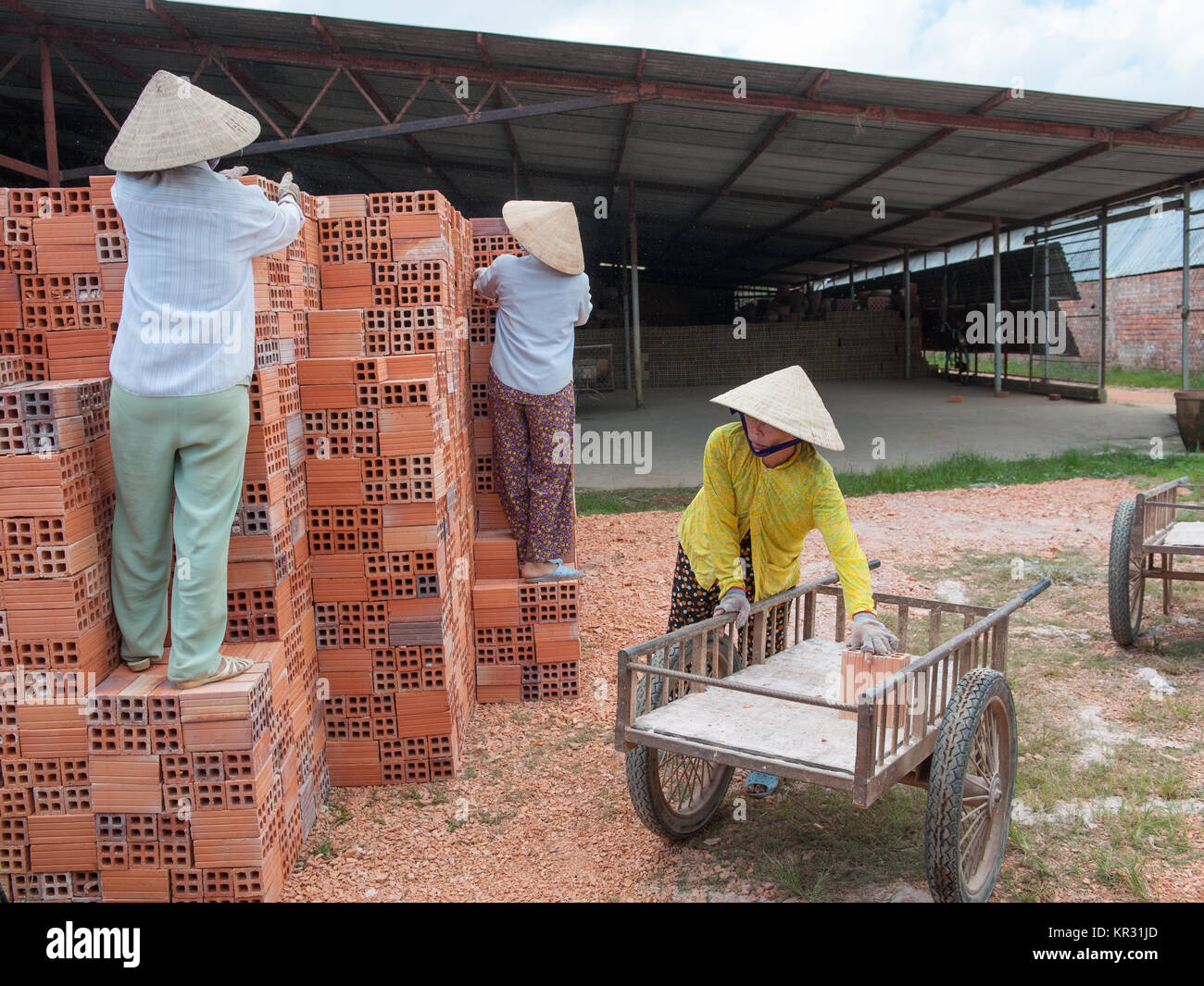 Vietnamese women work in an old brickworks in the Mekong delta. The Mekong delta has become popular among tourists wishing to experience rural Vietnam Stock Photo