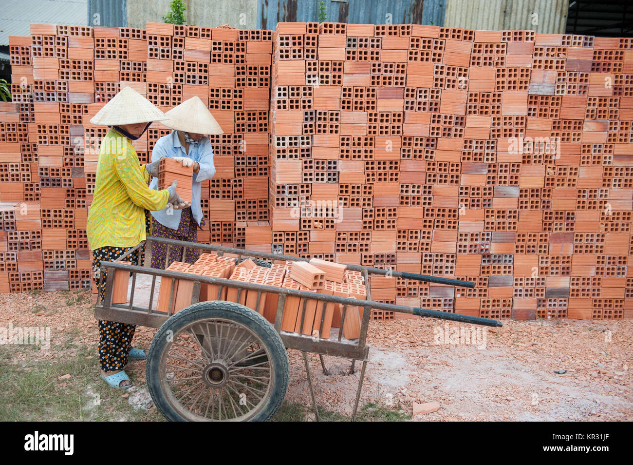 Vietnamese women work in an old brickworks in the Mekong delta. The Mekong delta has become popular among tourists wishing to experience rural Vietnam Stock Photo