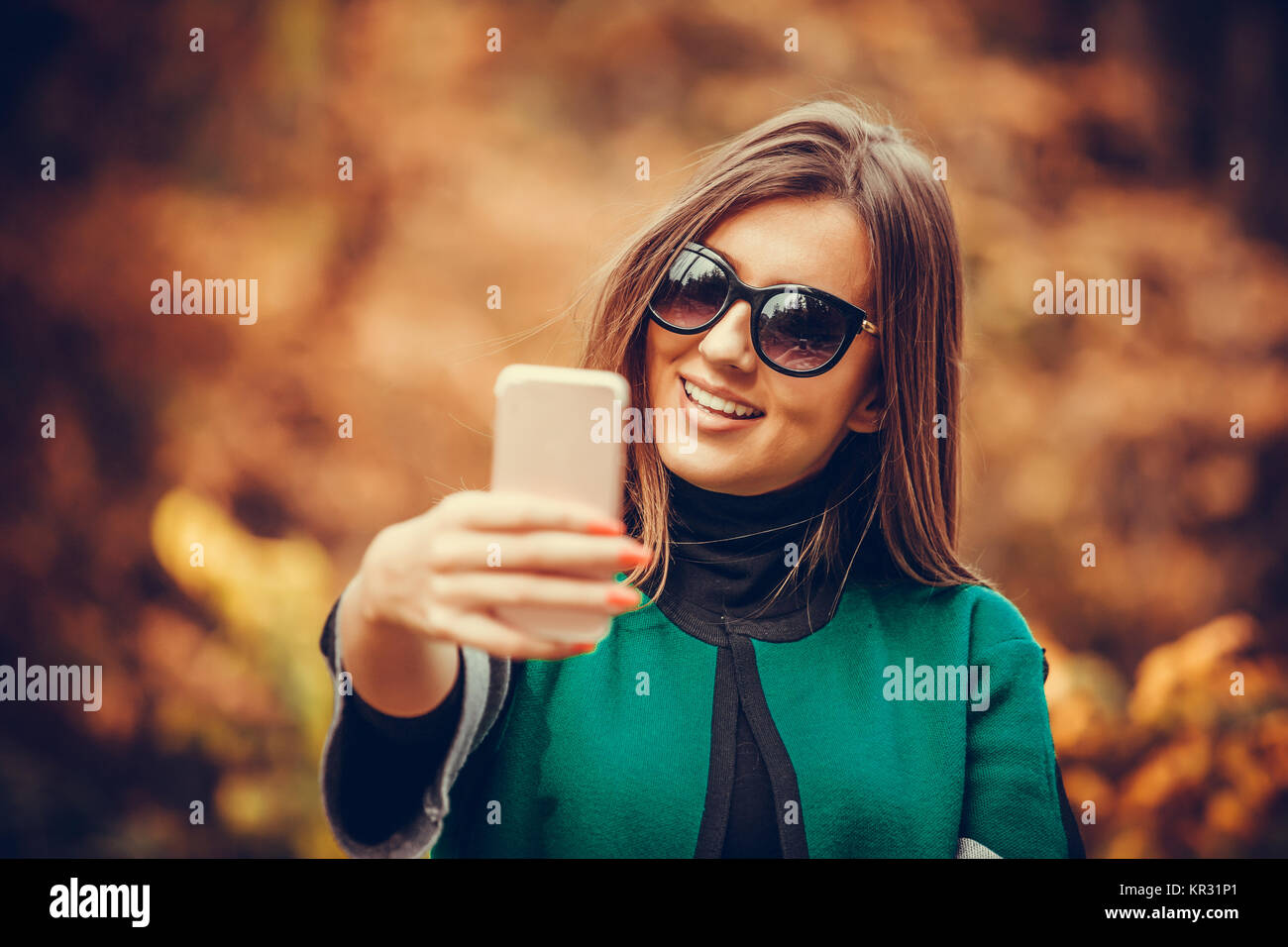Young beautiful and attractive woman makes selfie with mobile phone in ...