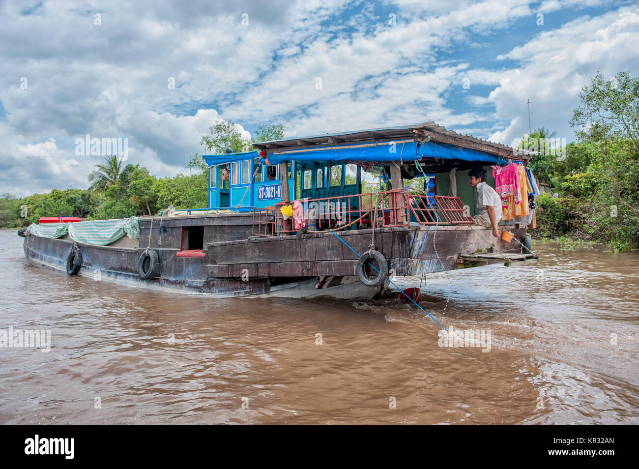 Traditional boat in the Mekong delta near Vinh Long, Vietnam. The Mekong river is a major route for transportation in Southeast Asia. Stock Photo