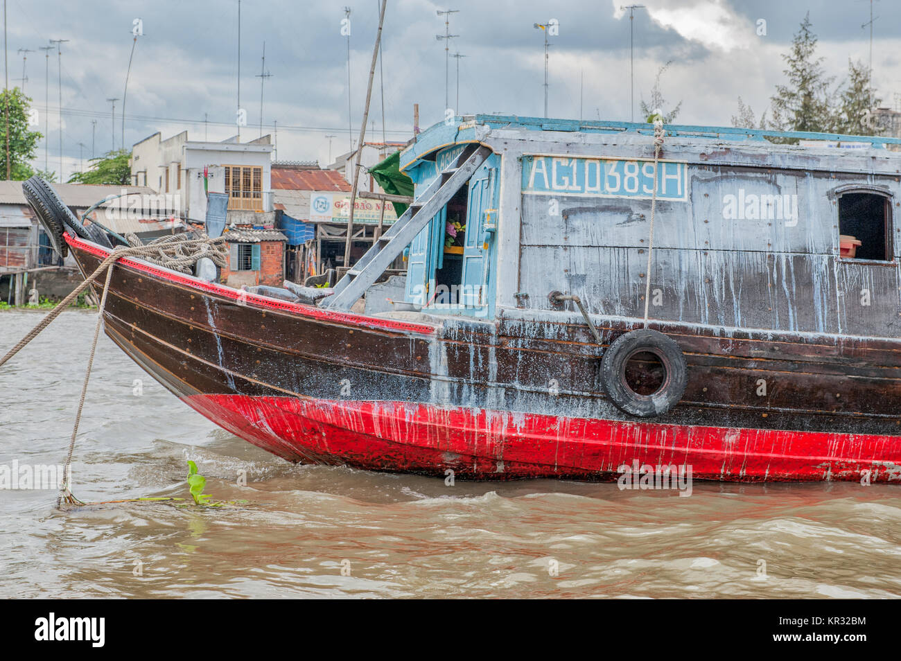 Traditional boat in the Mekong delta near Vinh Long, Vietnam. The Mekong river is a major route for transportation in Southeast Asia. Stock Photo