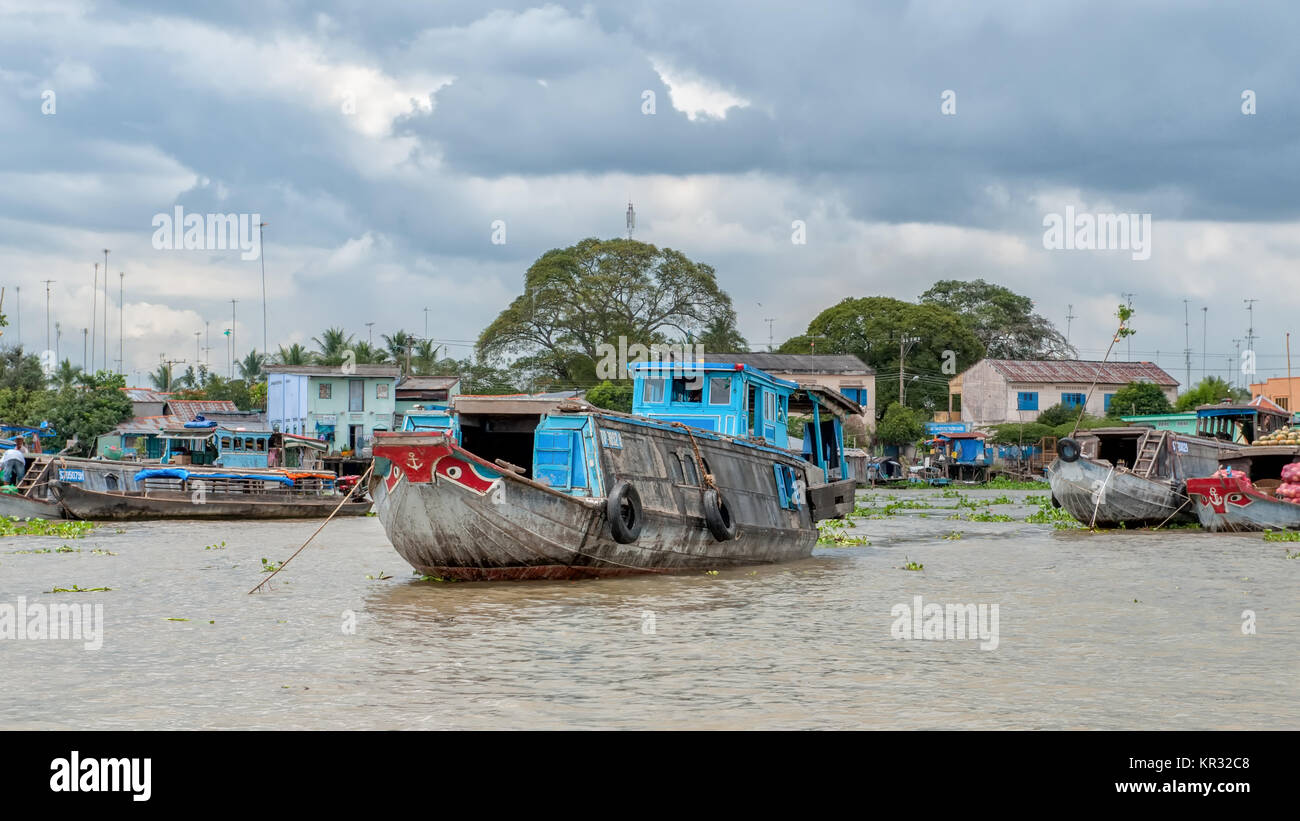 Traditional boats in the Mekong delta near Vinh Long, Vietnam. The Mekong river is a major route for transportation in Southeast Asia. Stock Photo