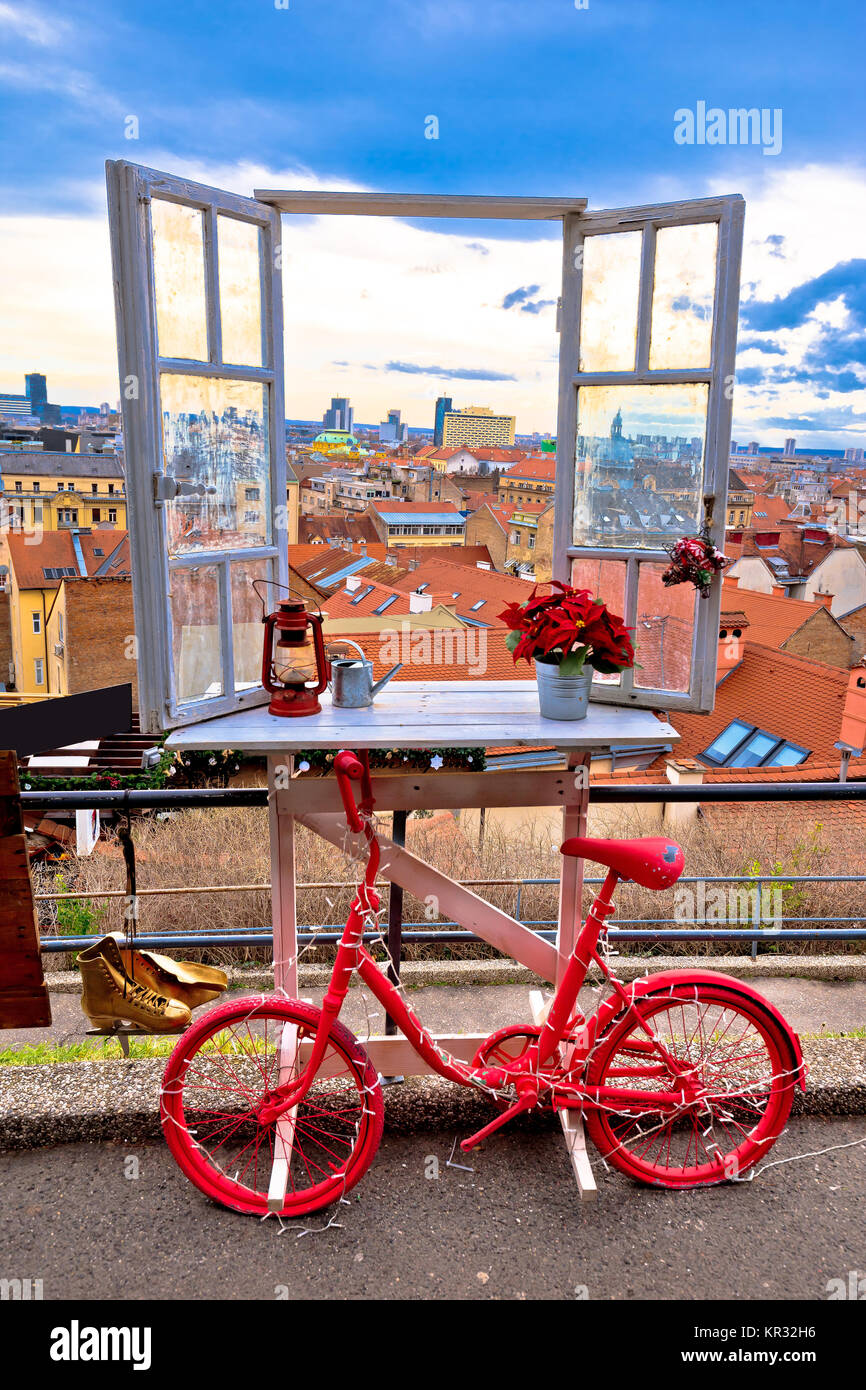 Idyllic Zagreb upper town Christmas market decorations, view through window on city rooftops and bicycle view, capital of Croatia Stock Photo