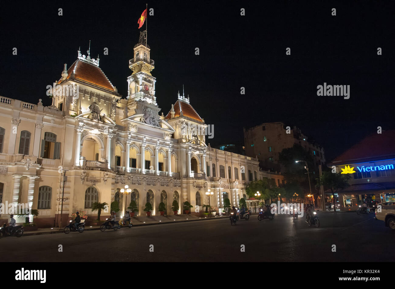 Ho Chi Minh City Hall by night. Formerly known as Hotel de Ville it was built in French colonial style and remains Saigon’s most iconic building. Stock Photo