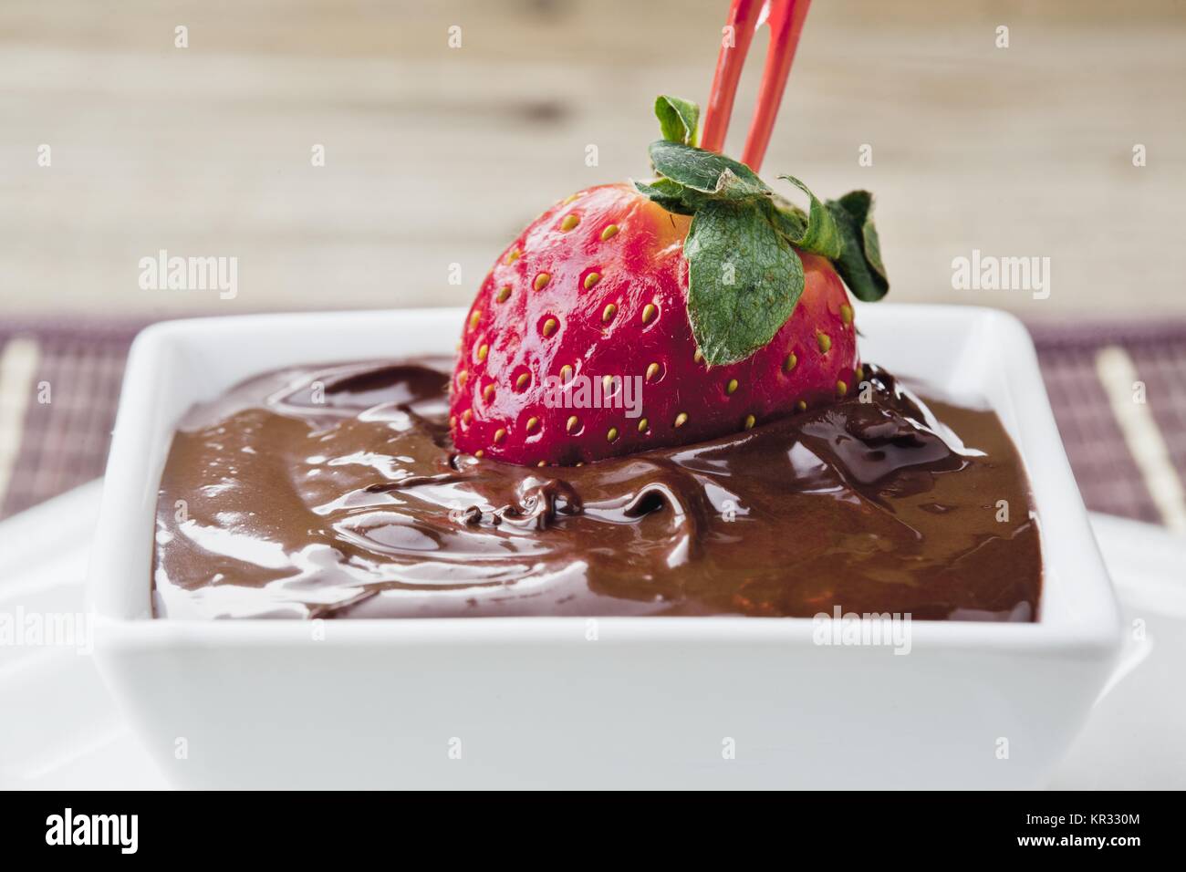 strawberry dipped in melted chocolate in bowl Stock Photo
