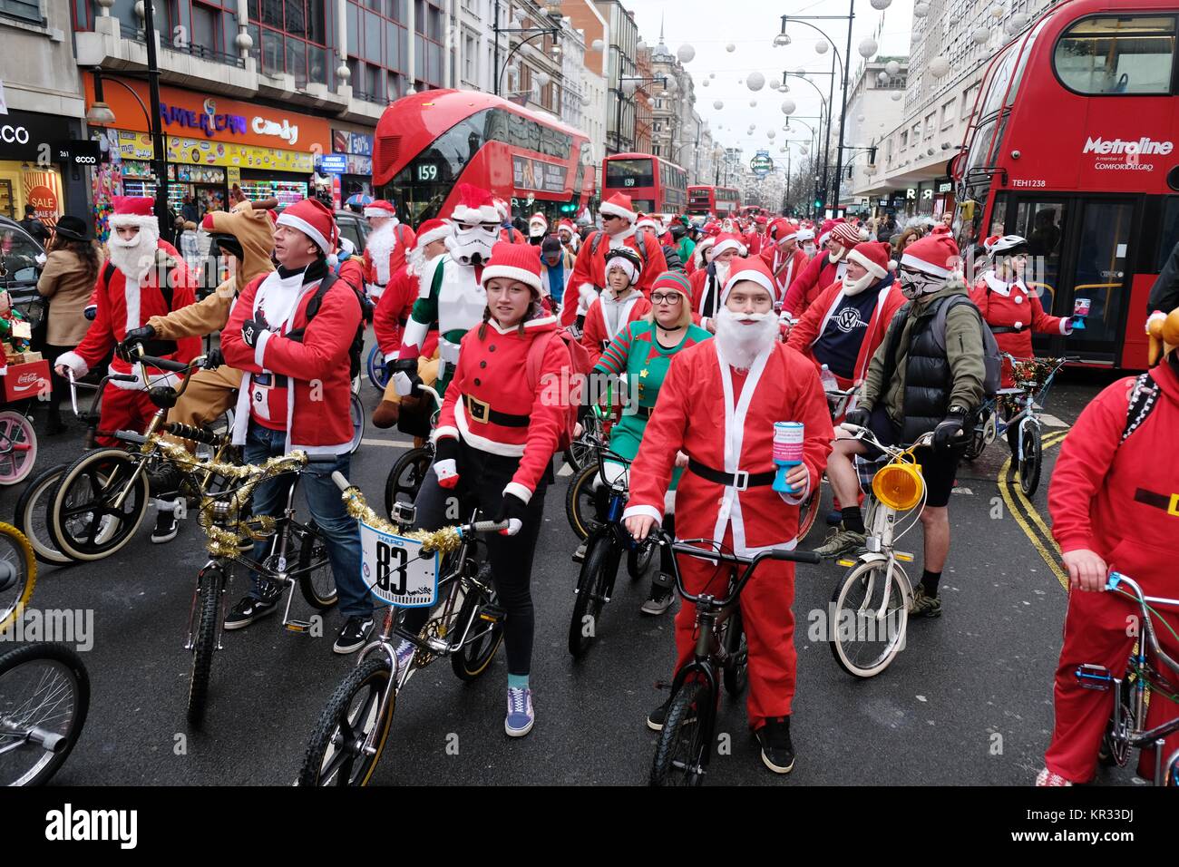 Pic shows: Santa bike rally down Oxford Street collecting for St Thomas' Hospital today.  600 cyclists dressed as Santa or elves cheered the shoppers  Stock Photo