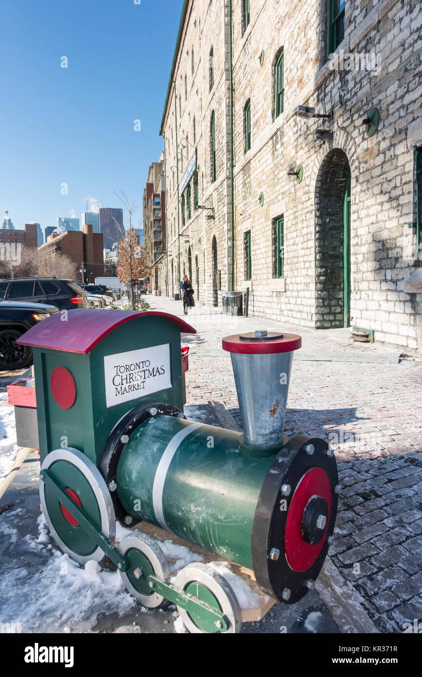 Small model train at the rear entrance of the Toronto Christmas market which held each year at the revitalized distillery district Stock Photo