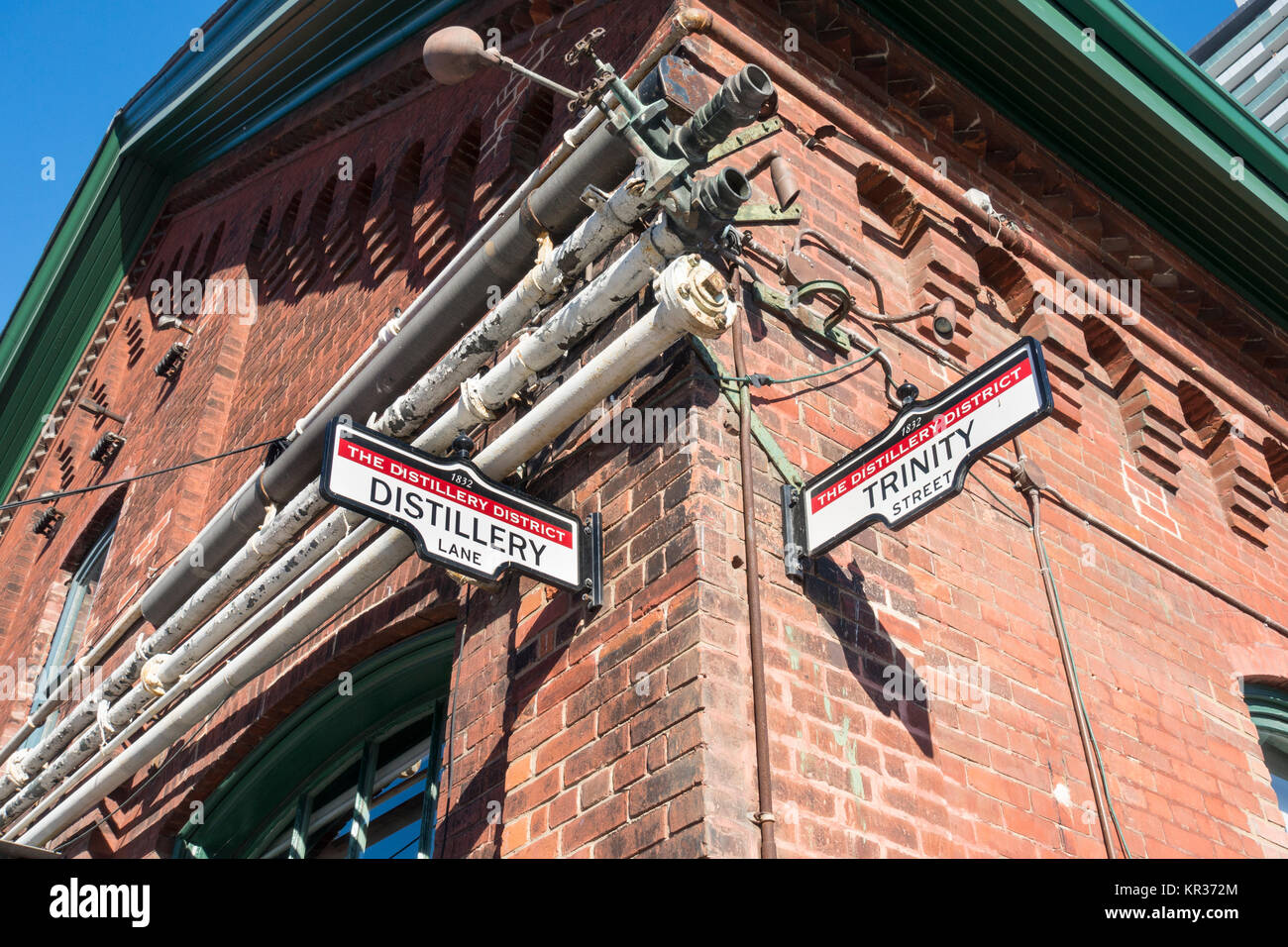 Signs on the side of a building at the intersection of Distillery lane and Trinity in the historic distillery tourist district in Toronto Canada Stock Photo