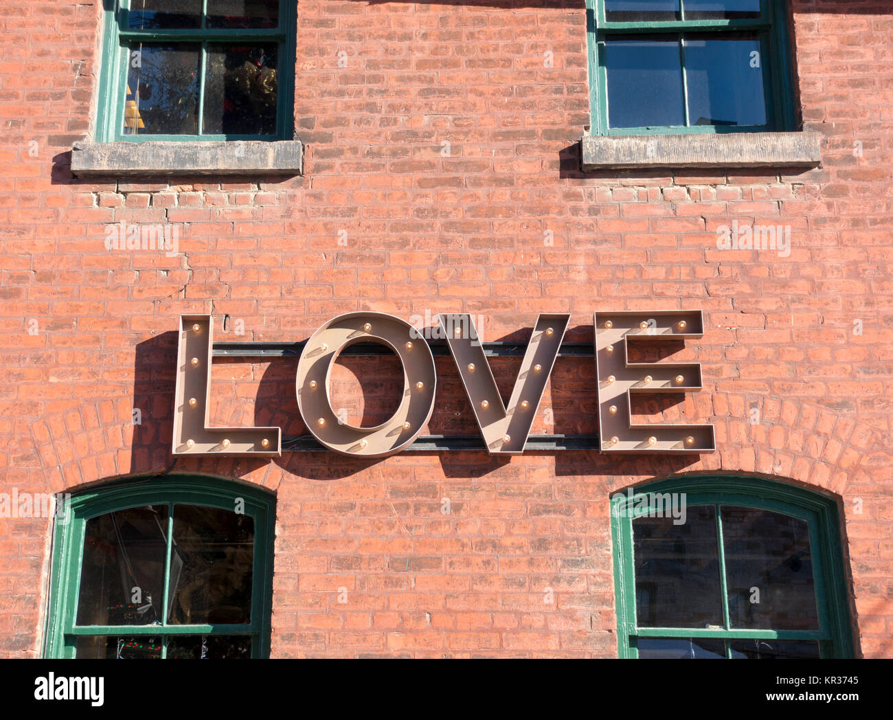 Illuminated sign that reads 'love', one of many installed during the Toronto Christmas market at the historic Distillery district. Stock Photo