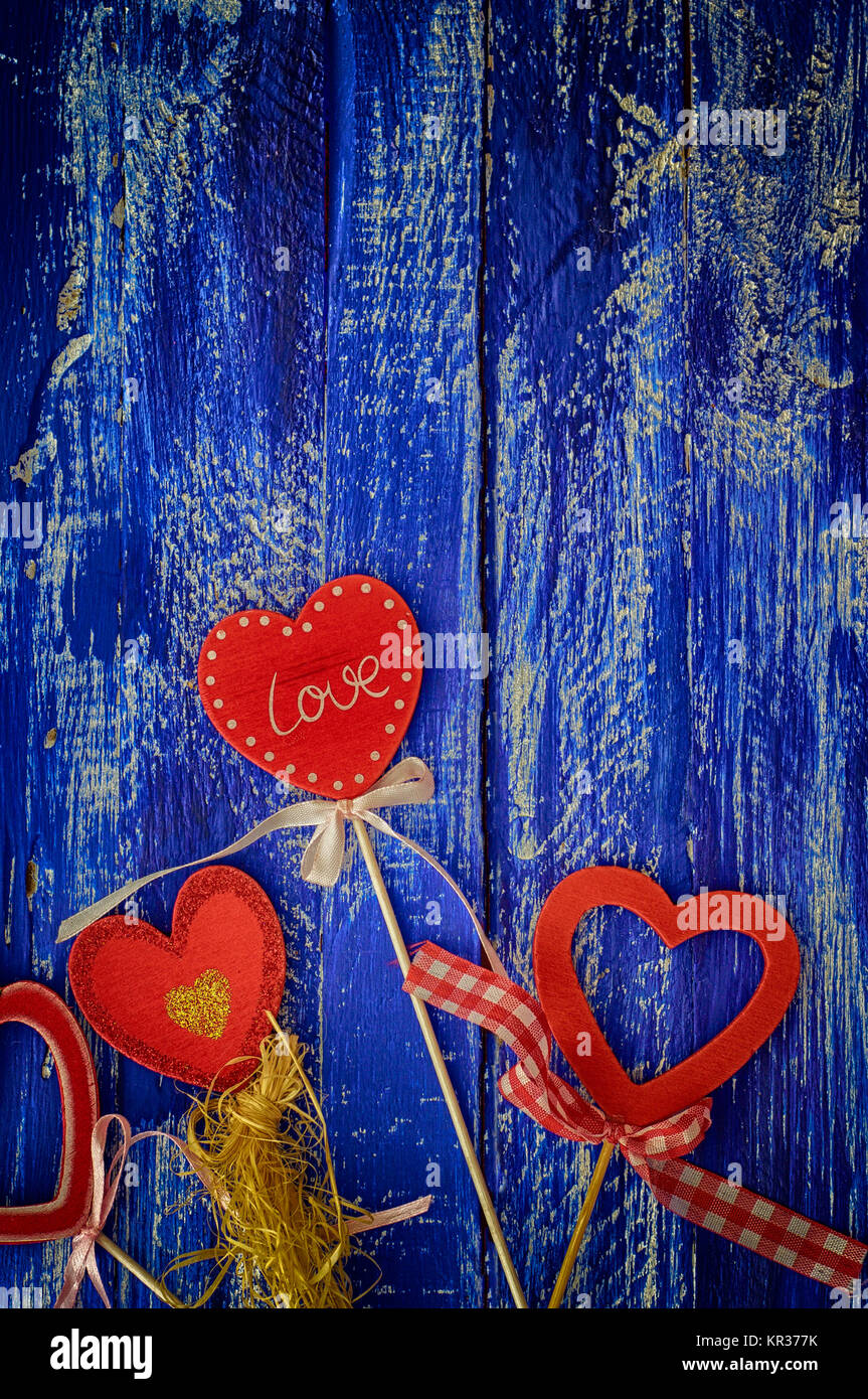 Wooden blue background with red wooden hearts Stock Photo - Alamy