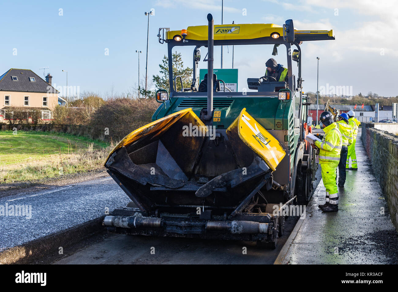 Workmen resurface the road near Skibbereen, West Cork, Ireland. Stock Photo