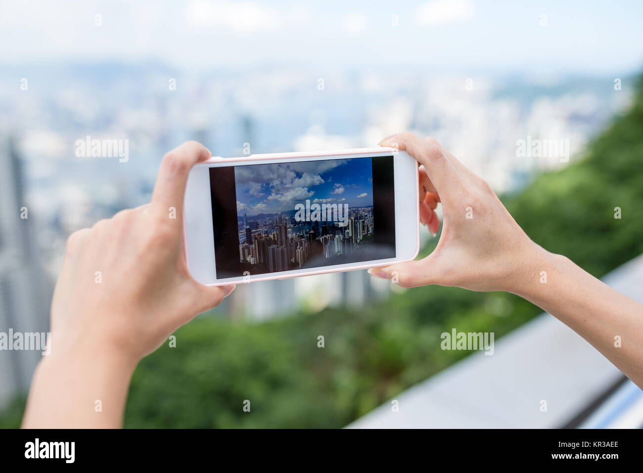Woman taking photo on city view of Hong Kong with cellphone Stock Photo ...
