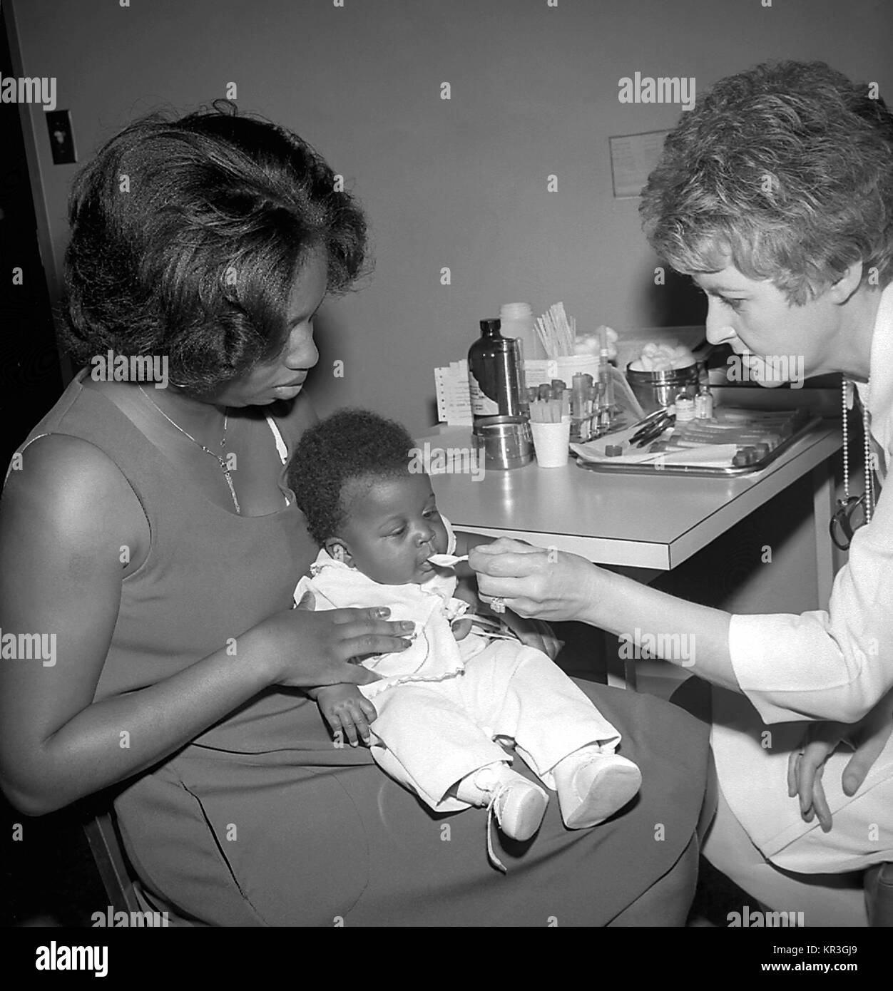 A photograph depicting the oral administration of Polio vaccine in order to immunize this infant to the disease. Polio immunization at the Well-Baby Clinic in Dekalb County, Georgia, 1977, 1977. Image courtesy CDC/Meridith Hickson. Stock Photo