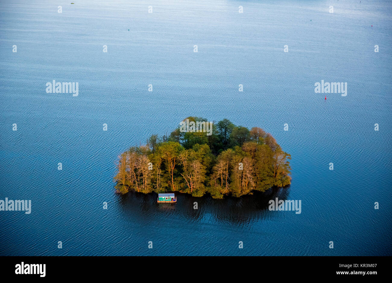 The Muritz with heart-shaped island and residential boat and pleasure boat in the sunset, Vipperow, Mecklenburg Lake District, Mecklenburg Lake Distri Stock Photo