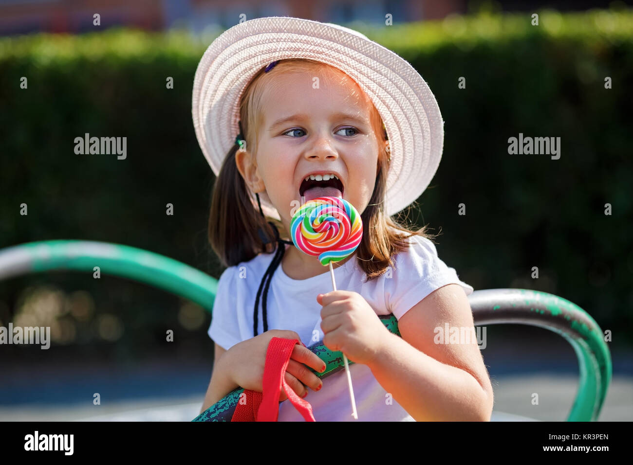 Nice little girl eating candy hires stock photography and images Alamy