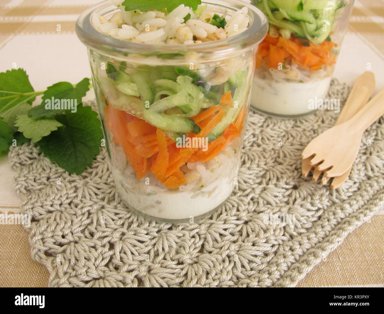 salads in glass with rice,barley,cucumber,carrot and yoghurt Stock Photo