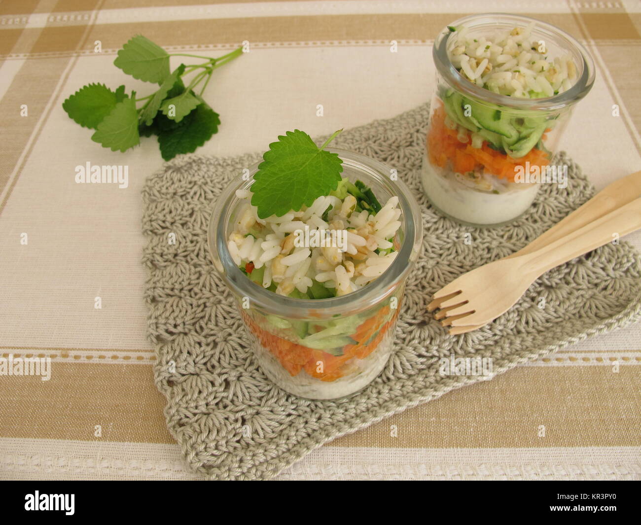 salads in glass with rice,barley,cucumber,carrot and yoghurt Stock Photo