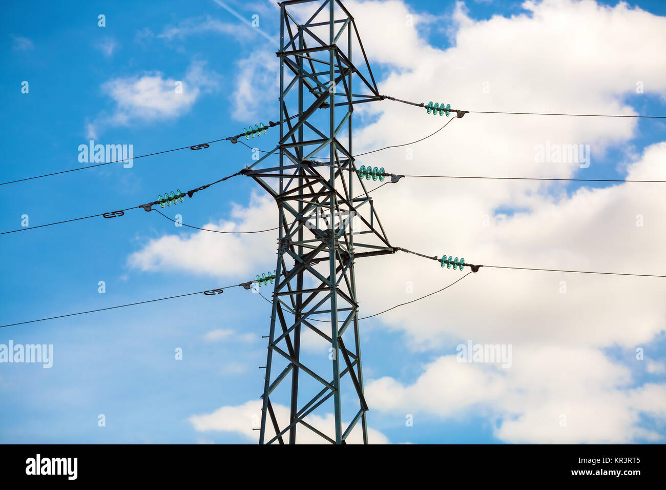 Electricity pylon against blue sky Stock Photo - Alamy