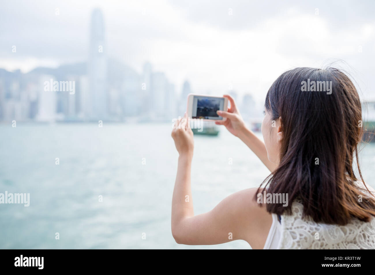 Woman taking photo of the skyline in Hong Kong Stock Photo - Alamy
