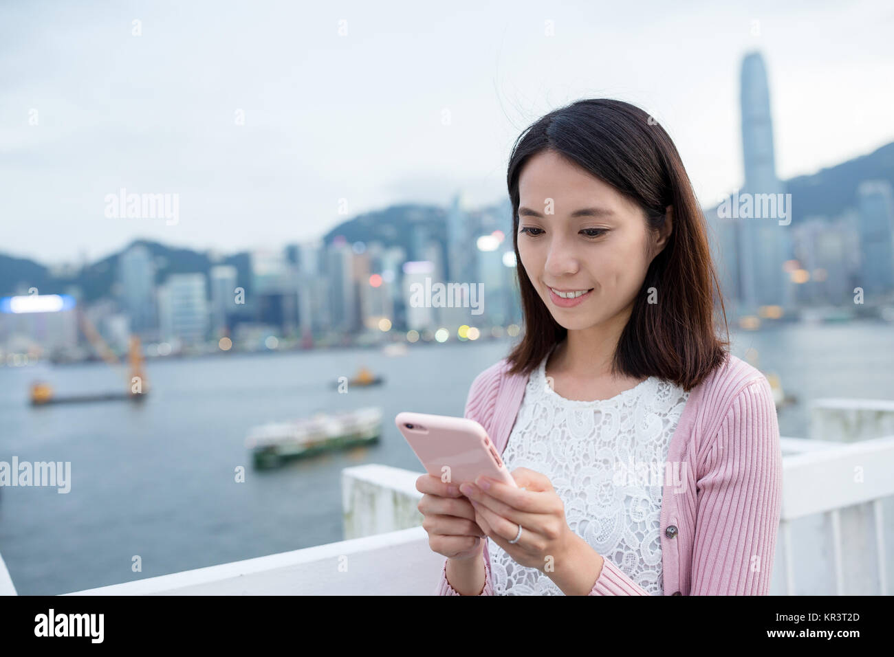 Woman hold cellphone at Hong Kong Stock Photo - Alamy