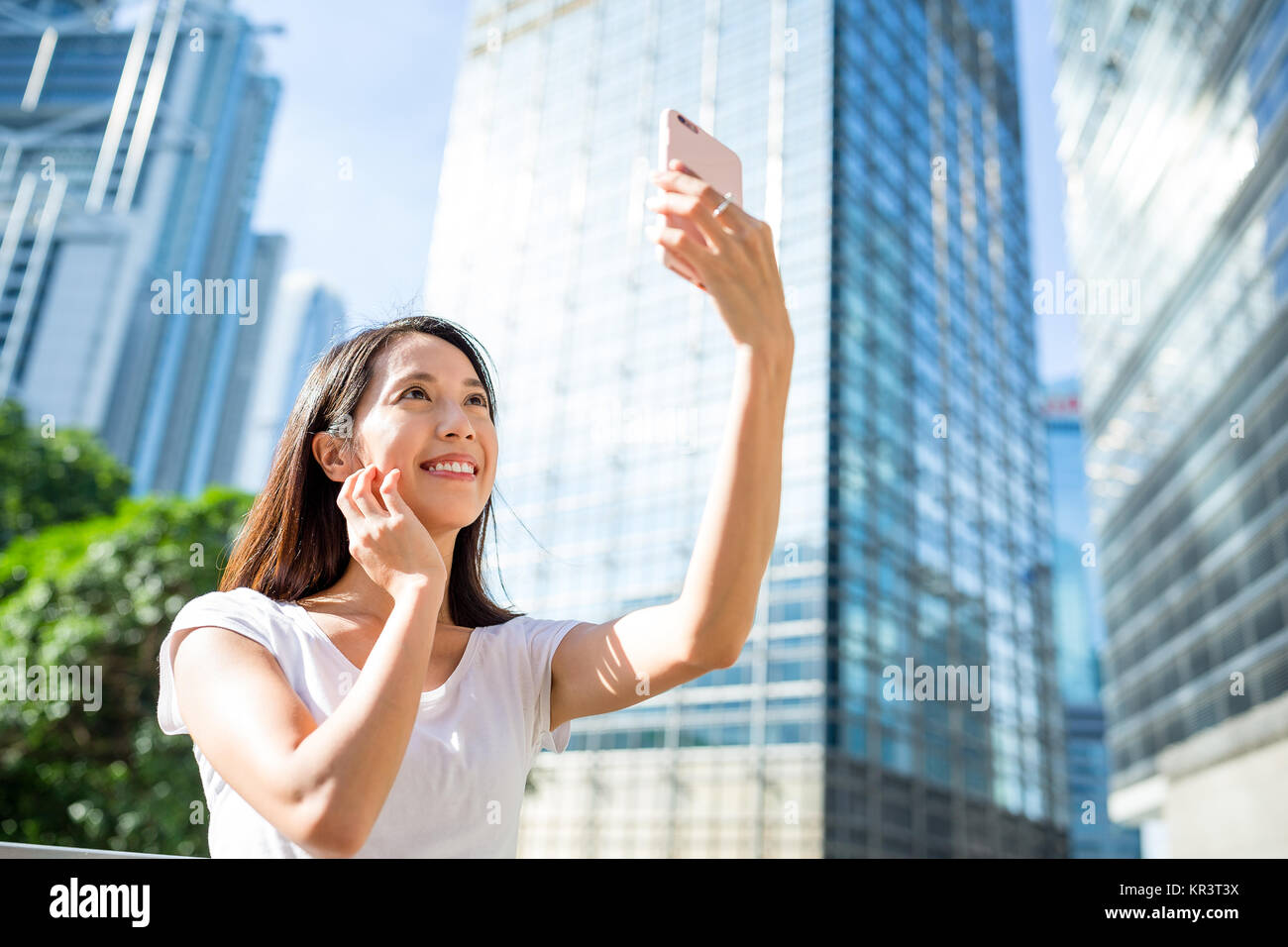 Woman taking photo by smart phone in Hong Kong Stock Photo - Alamy