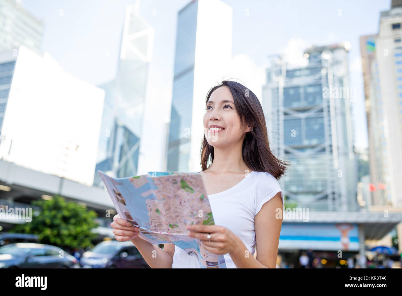 Woman holding a city map in Hong Kong city Stock Photo - Alamy