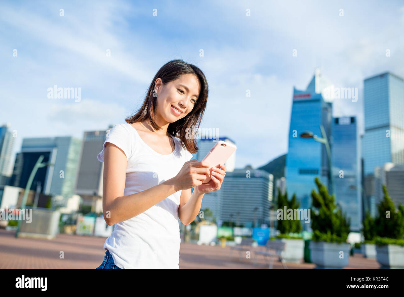 Woman using cellphone at city of Hong Kong Stock Photo - Alamy