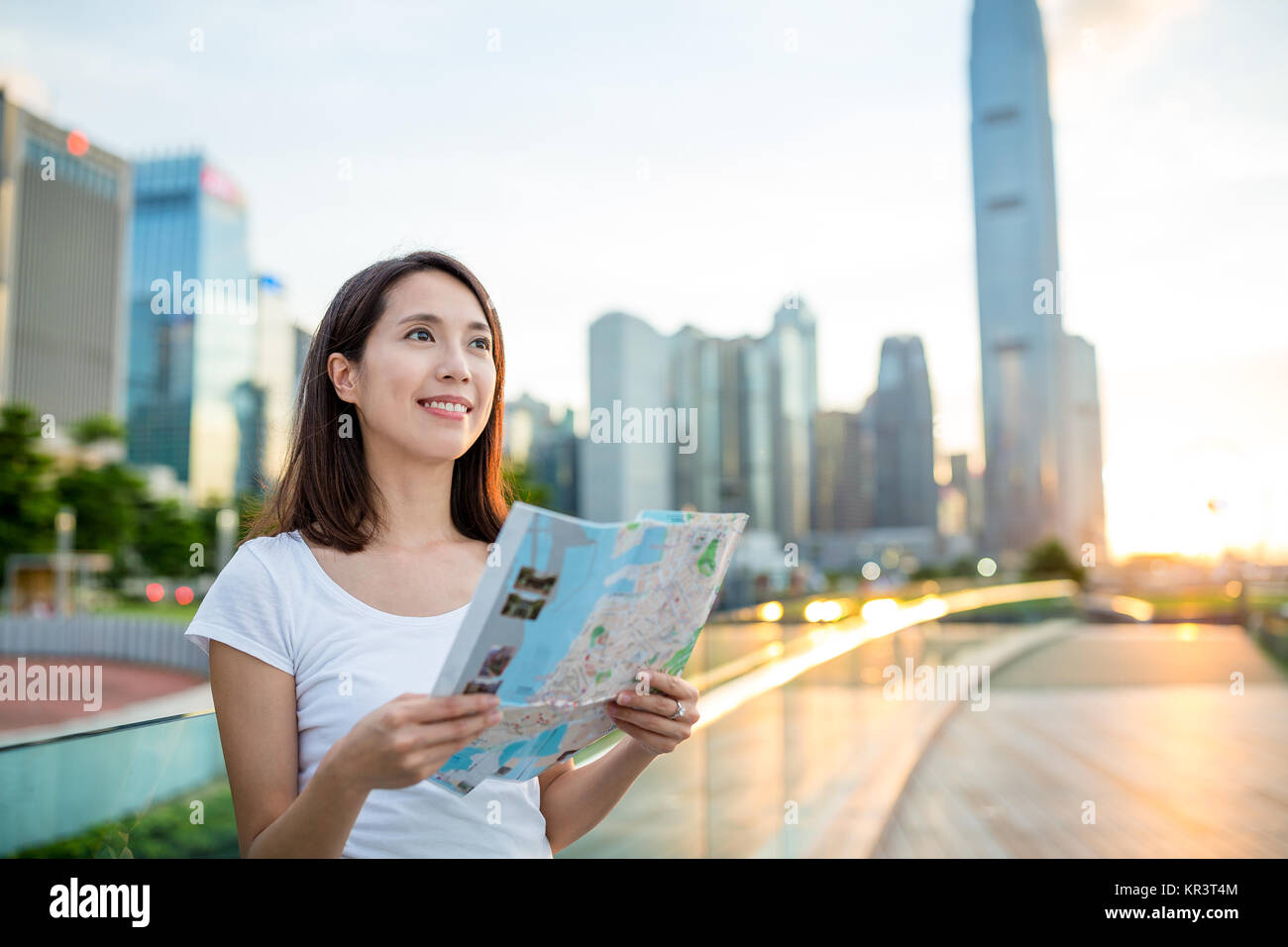 Woman using city map in Hong Kong city during sunset Stock Photo - Alamy