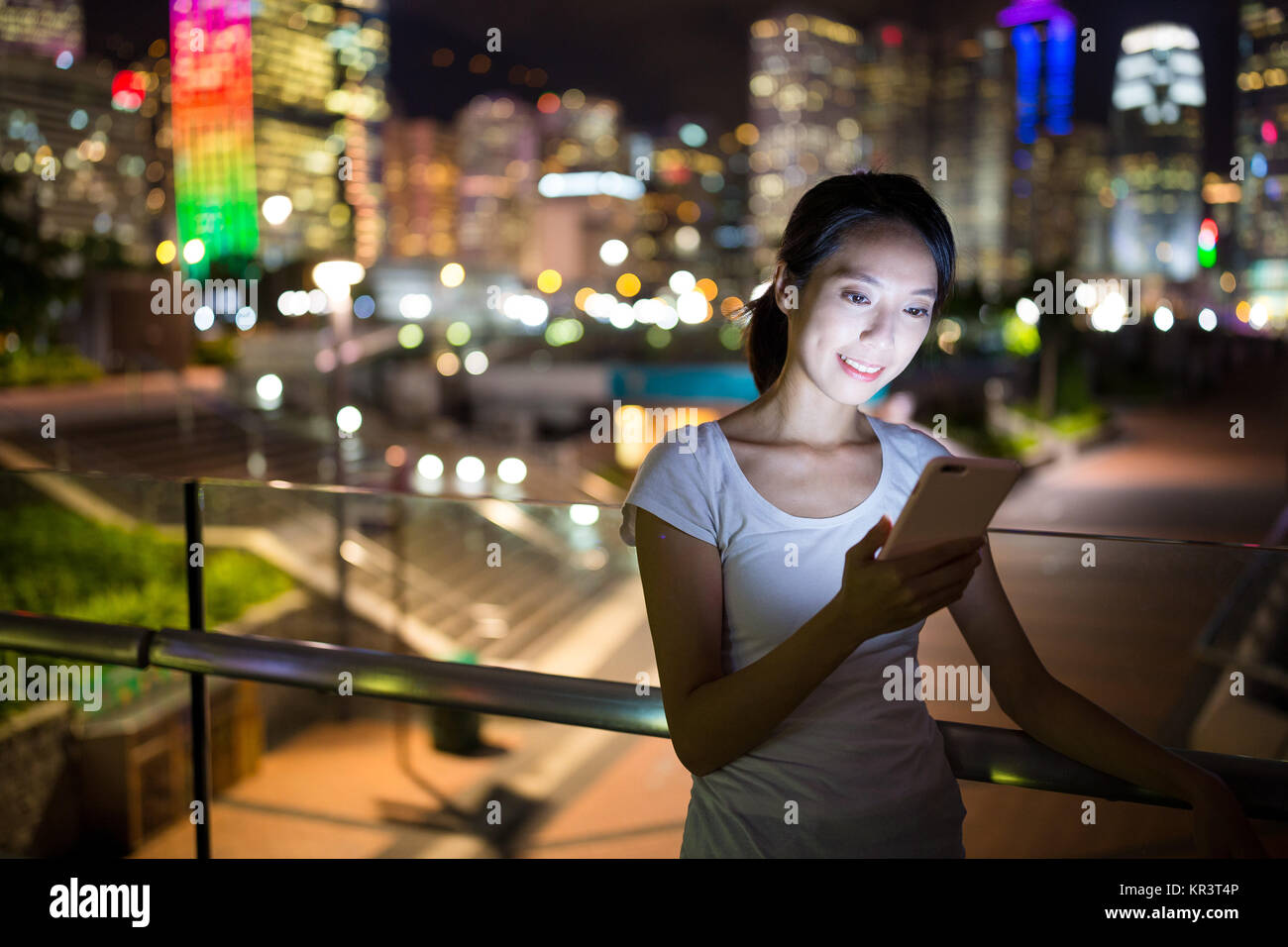 Asian woman use of mobile phone at night Stock Photo - Alamy