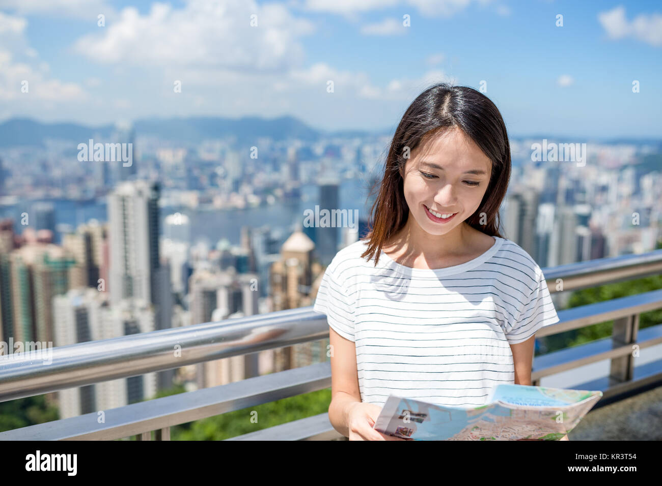 Woman looking at the city map in Hong Kong Stock Photo - Alamy