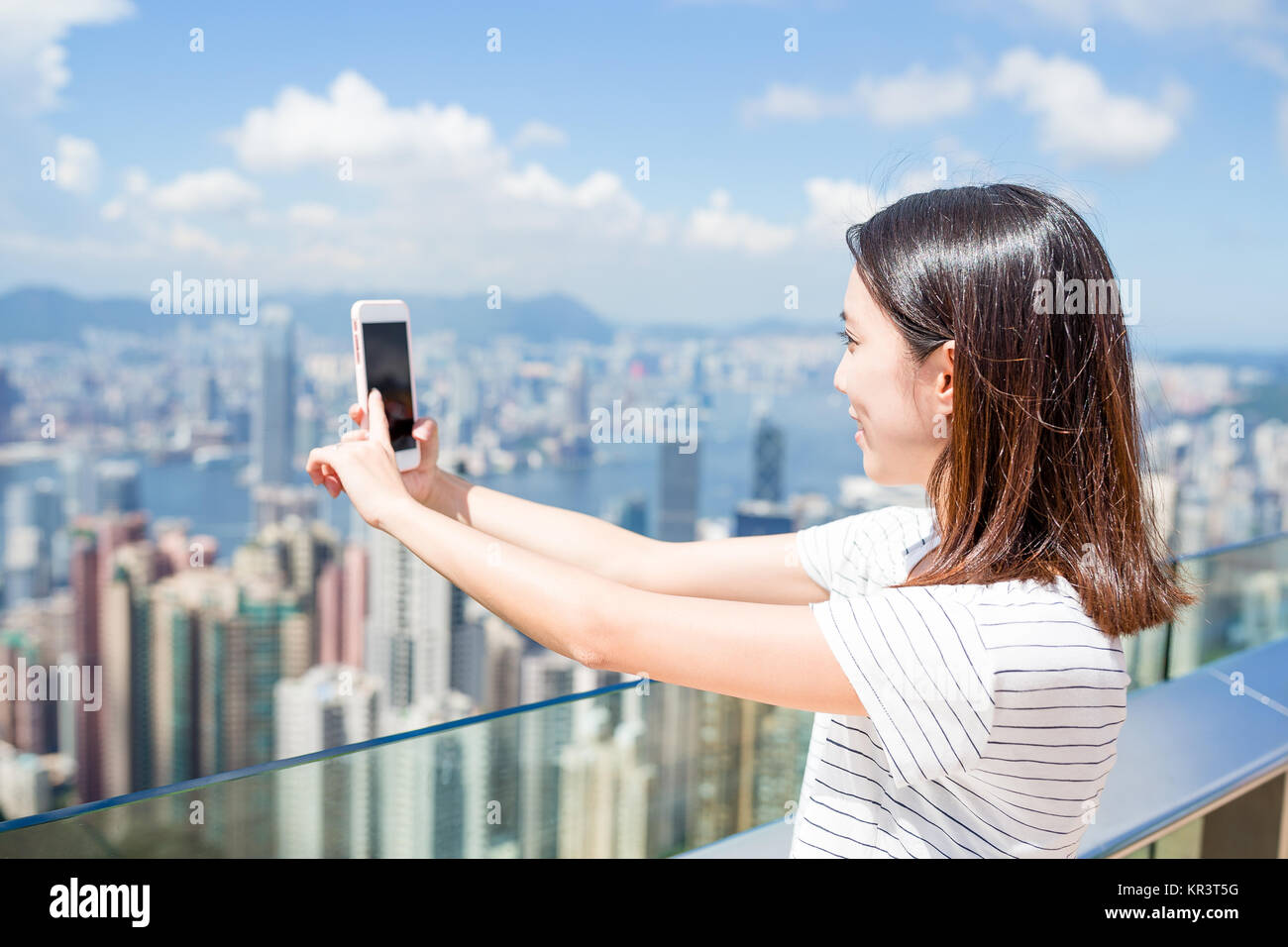 Woman taking photo of Hong Kong city Stock Photo - Alamy