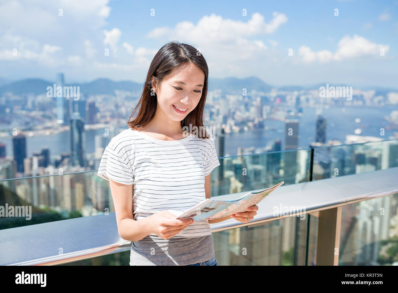 Woman looking at the city map in Hong Kong Stock Photo - Alamy