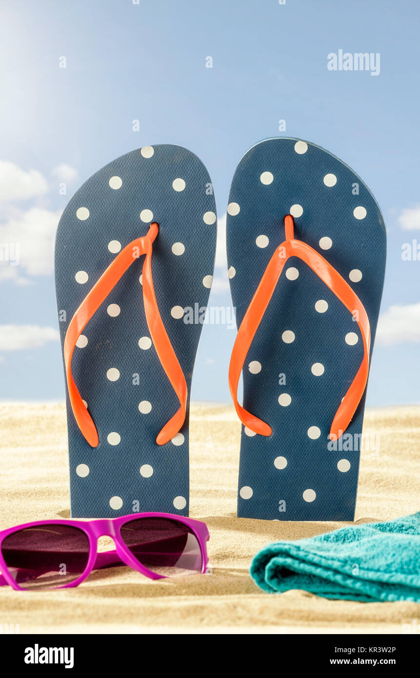 flip flops in the sand with sunglasses and beach towel Stock Photo - Alamy