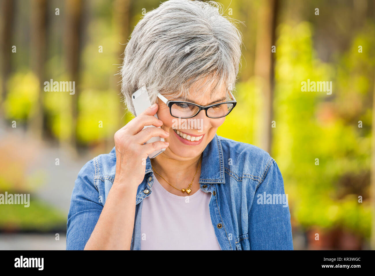 Mature woman talking at phone Stock Photo - Alamy