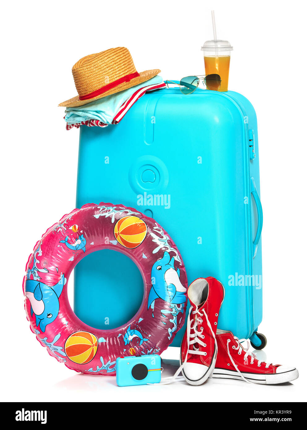 The blue suitcase, sneakers, hat and rubber ring on white background. Stock Photo