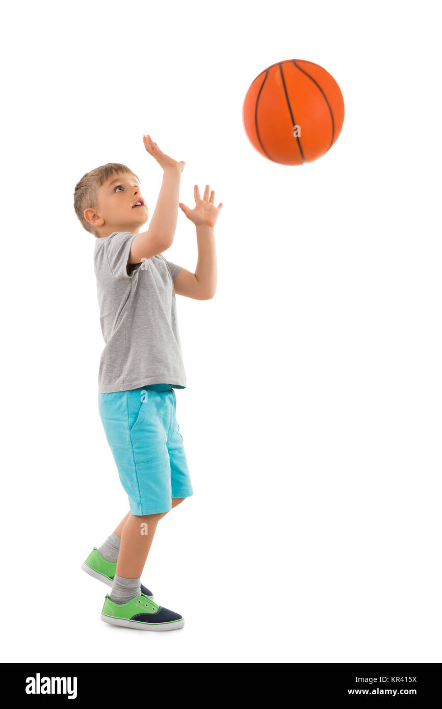 Boy Throwing Basketball Stock Photo Alamy