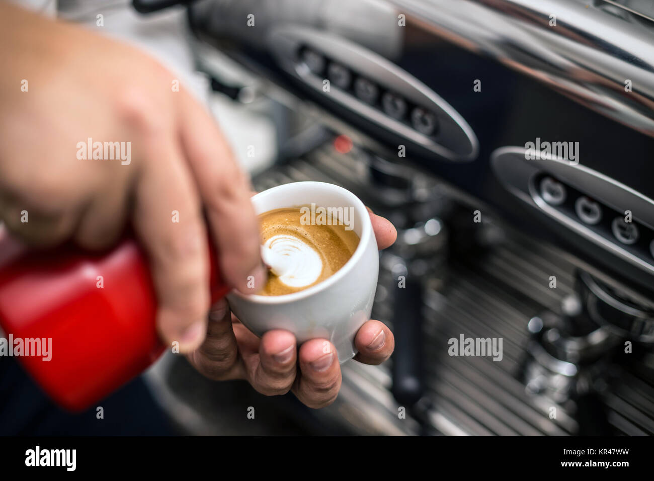 Barista preparing proper cappuccino Stock Photo