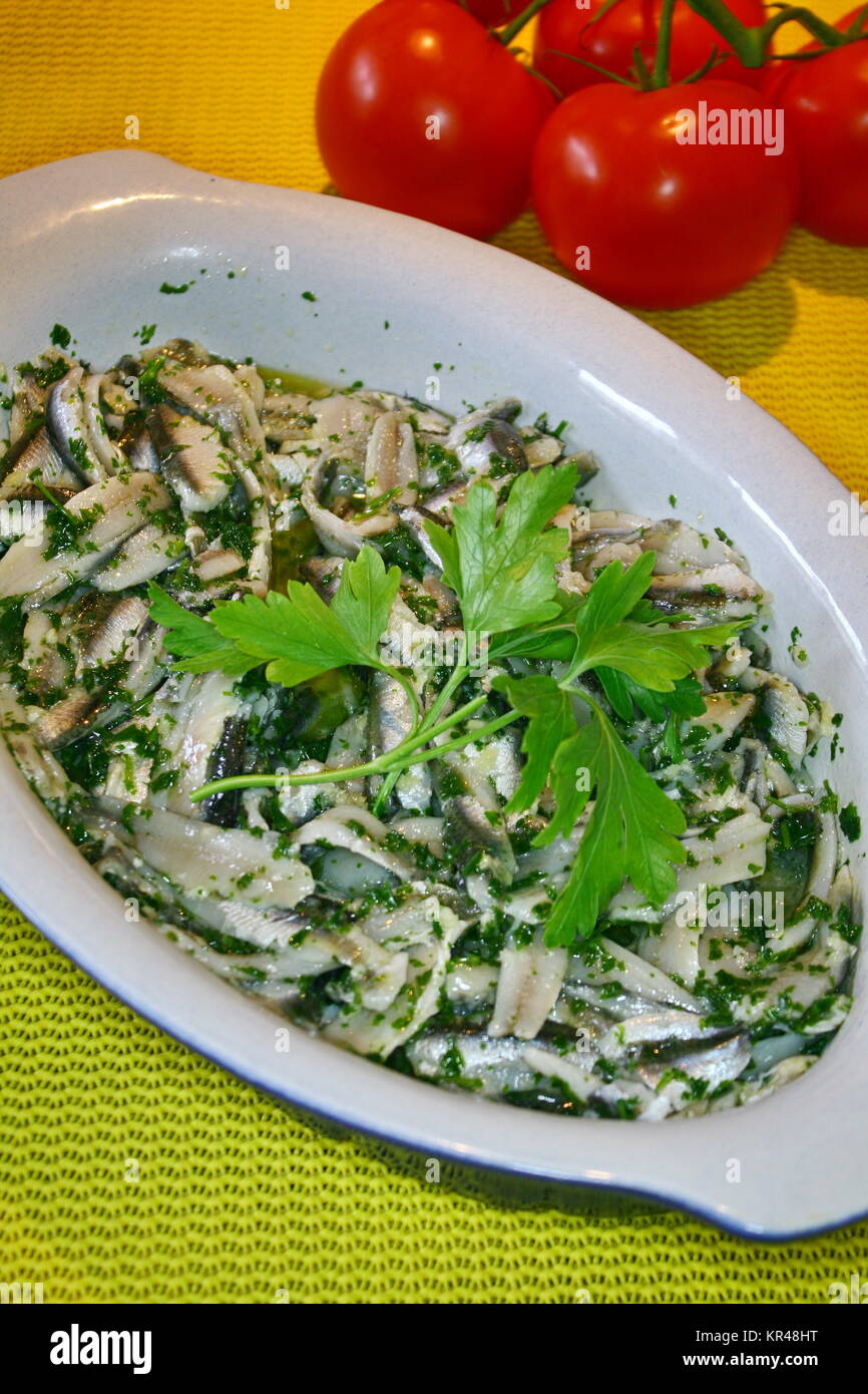 sardines,dressed with oil and vinegar,in a serving bowl,decorated with