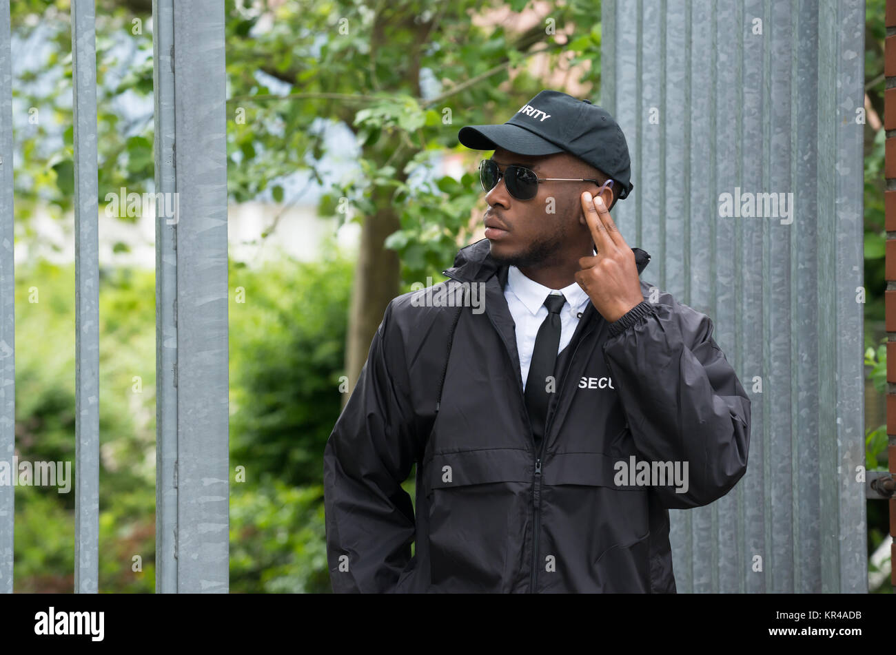 Security Guard Listening To Earpiece Stock Photo Alamy