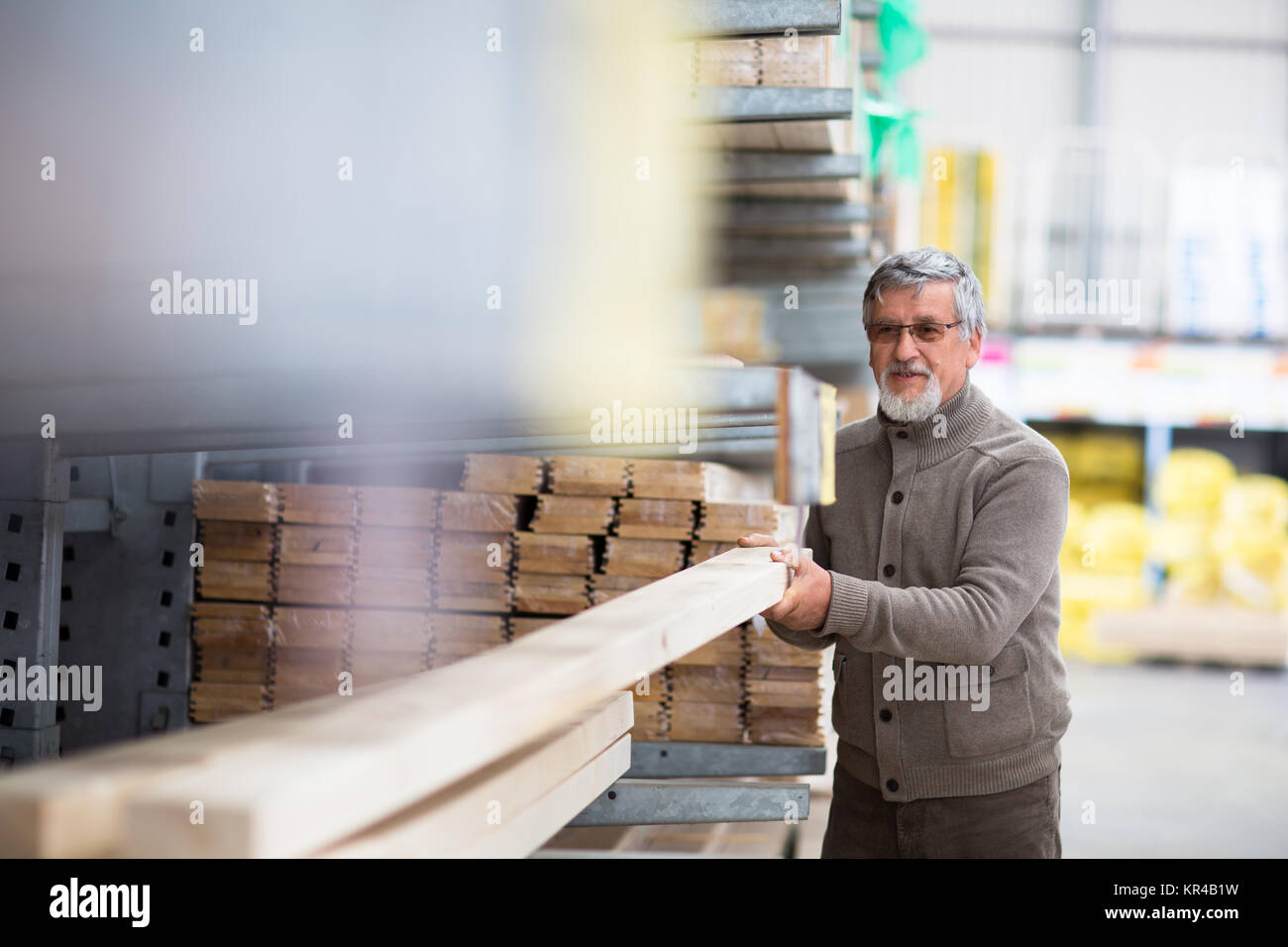 Man choosing and buying construction wood in a DIY store for his DIY