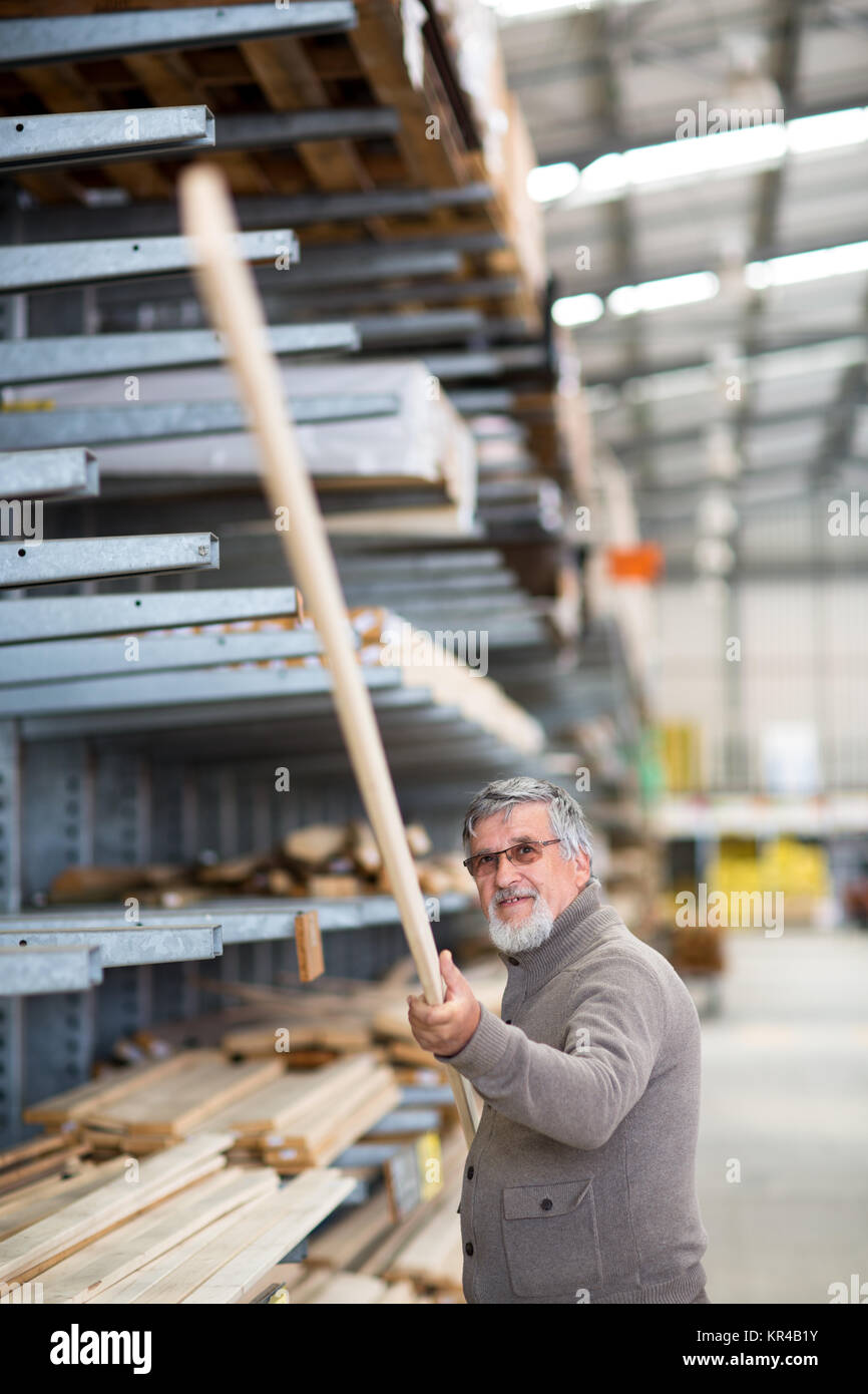 Man choosing and buying construction wood in a DIY store for his DIY