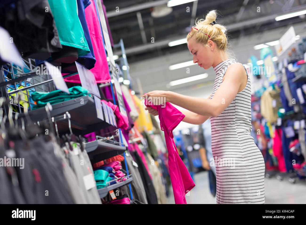 Woman shopping sportswear in sports store Stock Photo Alamy