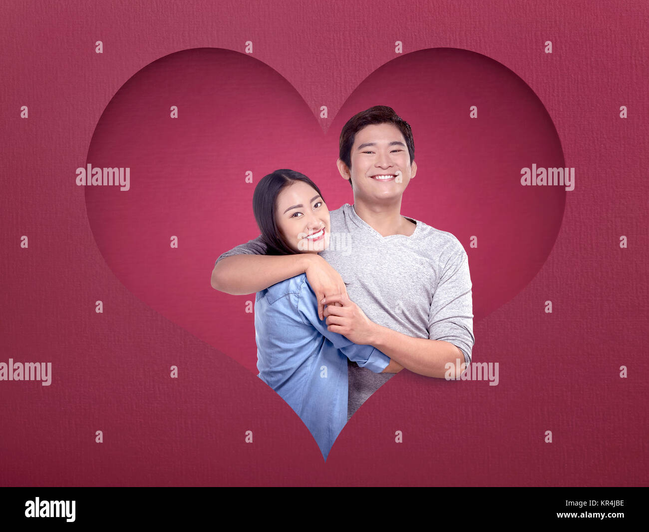 Image of asian couple in love embracing each other posing with heart ...