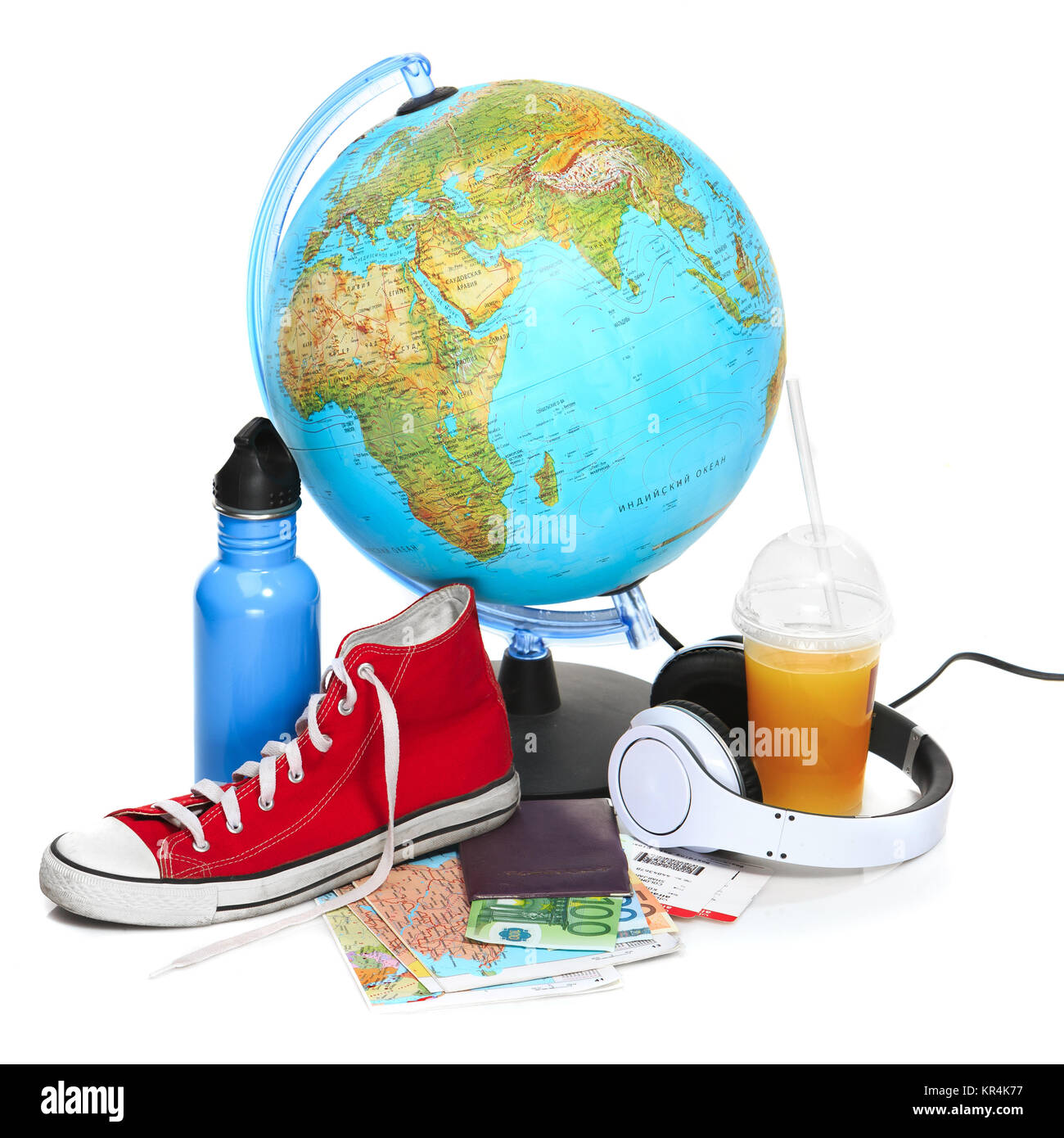 The blue globe, sneakers, thermos and headphones on white background. Stock Photo