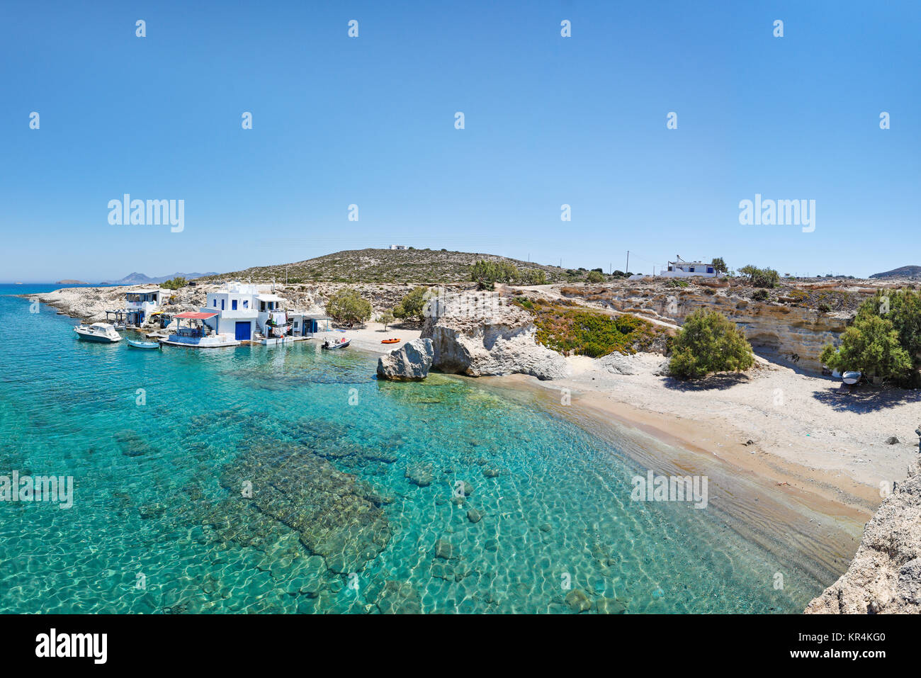 Traditional fishermen houses with the impressive boat shelters, also known as “syrmata” in Mytakas of Milos, Greece Stock Photo