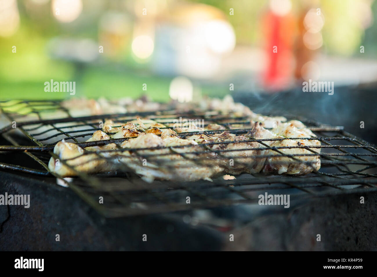 roasted duck on the charcoal grill. Preparation of meat slices in sauce